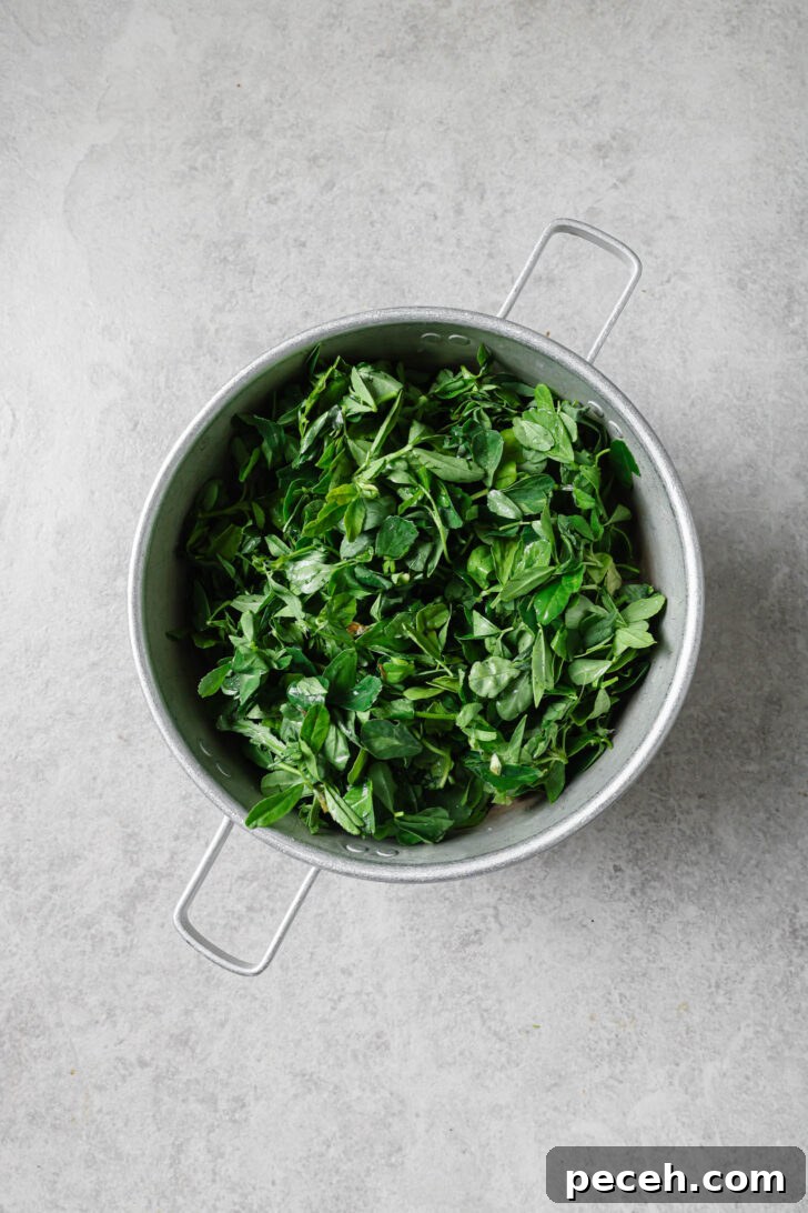 Authentic Aloo Methi (Potato & Fenugreek Leaves) Recipe from Mom-in-Law 7 Draining soaked fenugreek leave in a colander