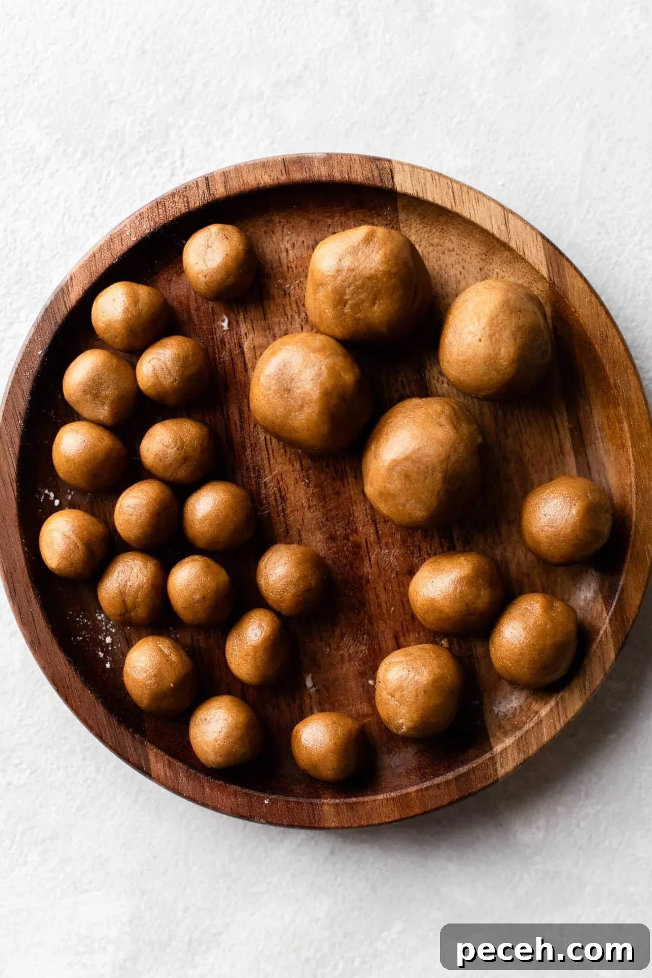 gingerbread cookie dough divided into portions for gingerbread man bodies, heads, and arms and legs in plate