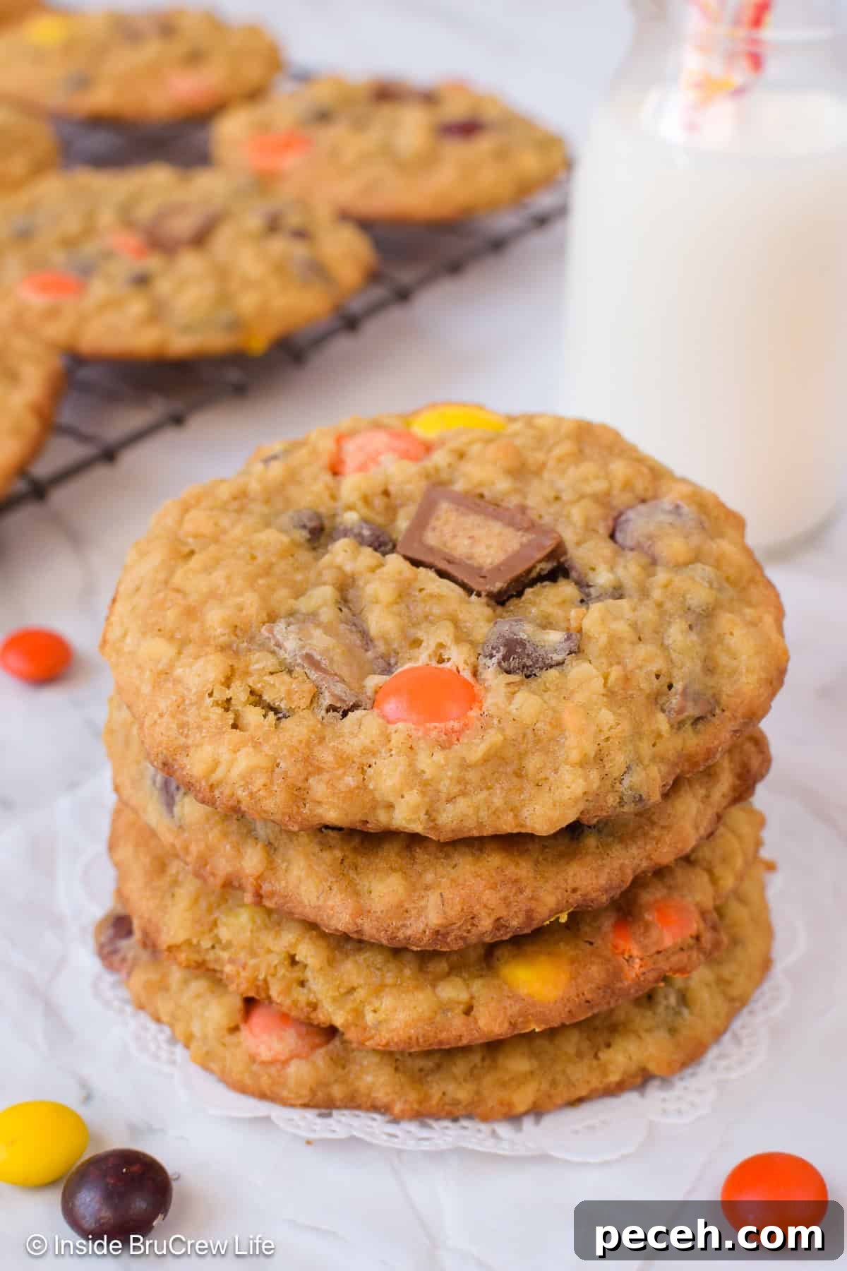 Peanut Butter Banana Oatmeal Cookies Recipe for Chewy Bites 5 A stack of peanut butter oatmeal cookies topped with Reese's candies.