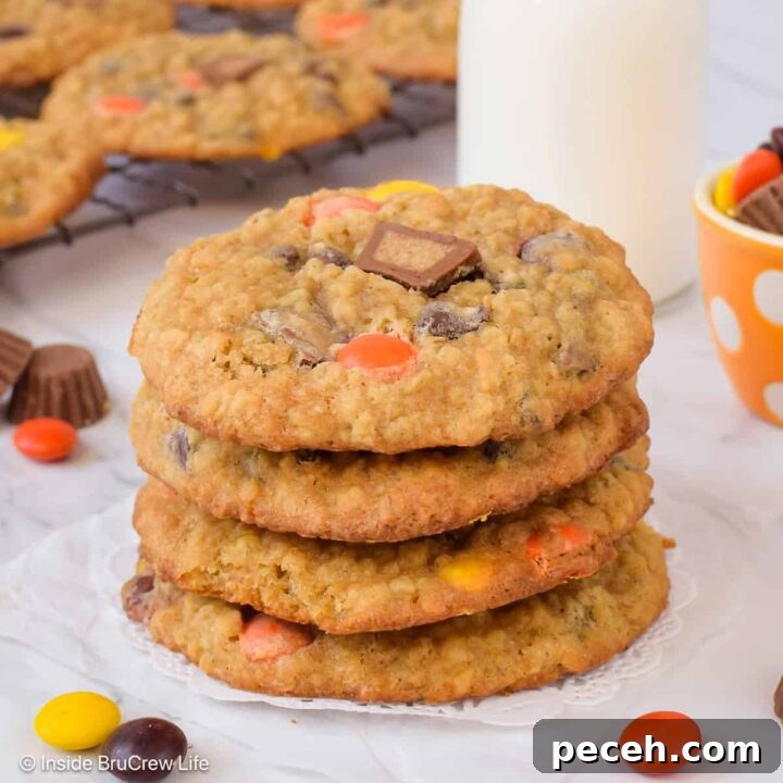 A stack of chewy peanut butter banana oatmeal cookies made with Reese's candies.
