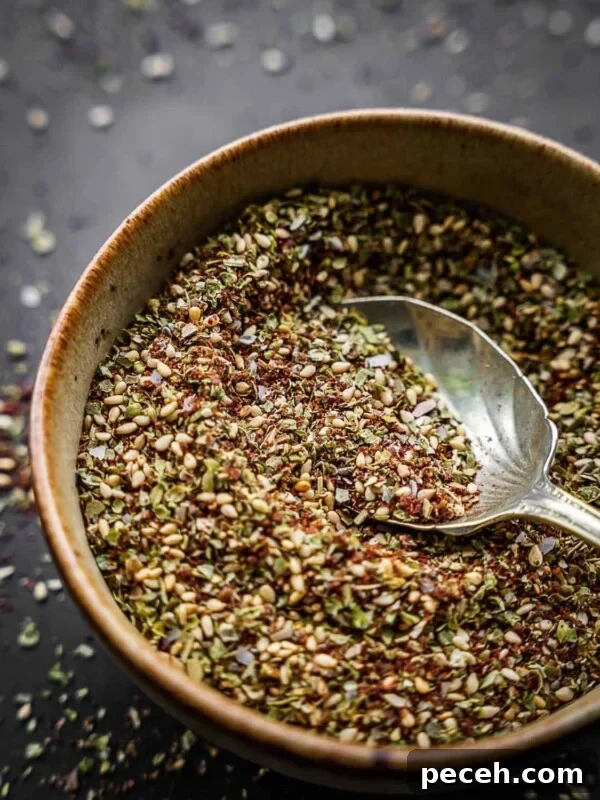 Za'atar spice blend in a bowl with an antique spoon.