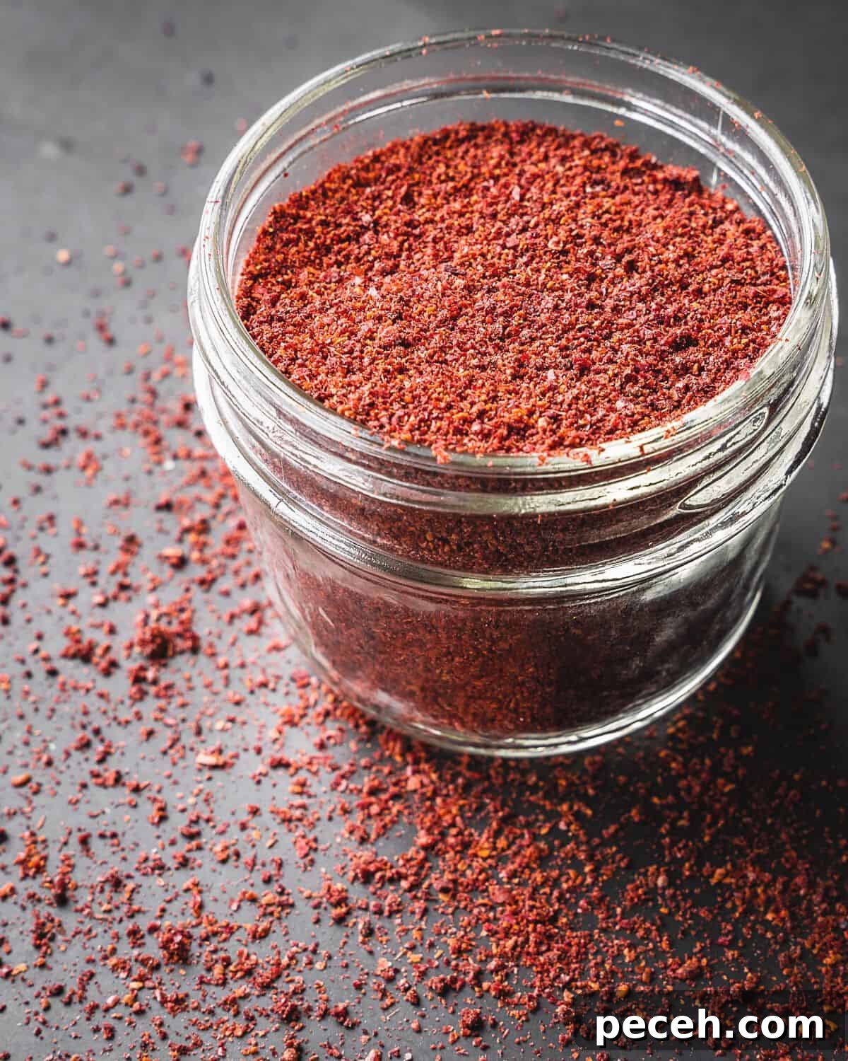 Sumac: History, Culinary Uses and Top Recipes 9 Sumac spice in an open mason jar.
