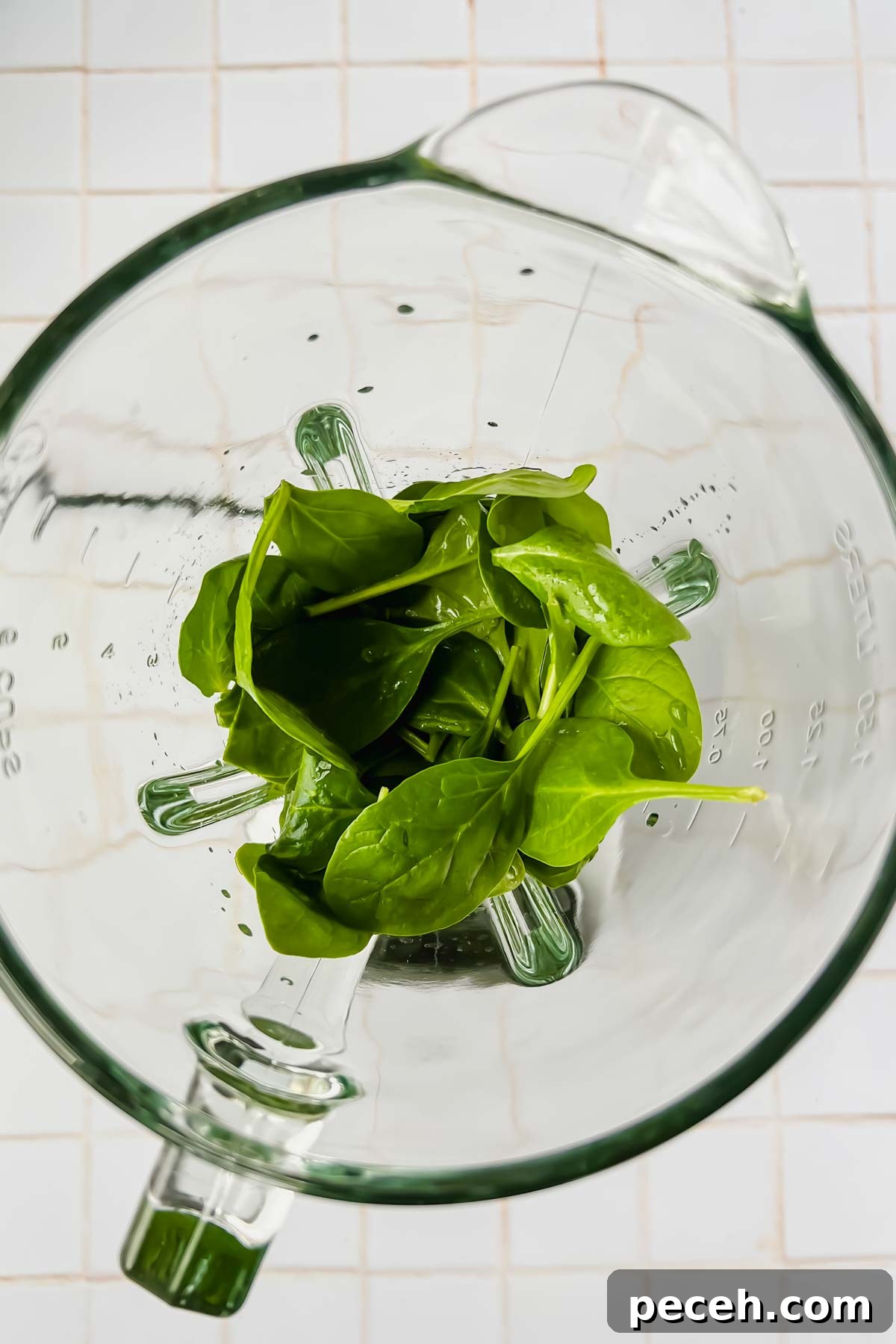 Mango Spinach Smoothie Recipe for Energy and Glow 4 fresh spinach and cold filtered water added to blender.
