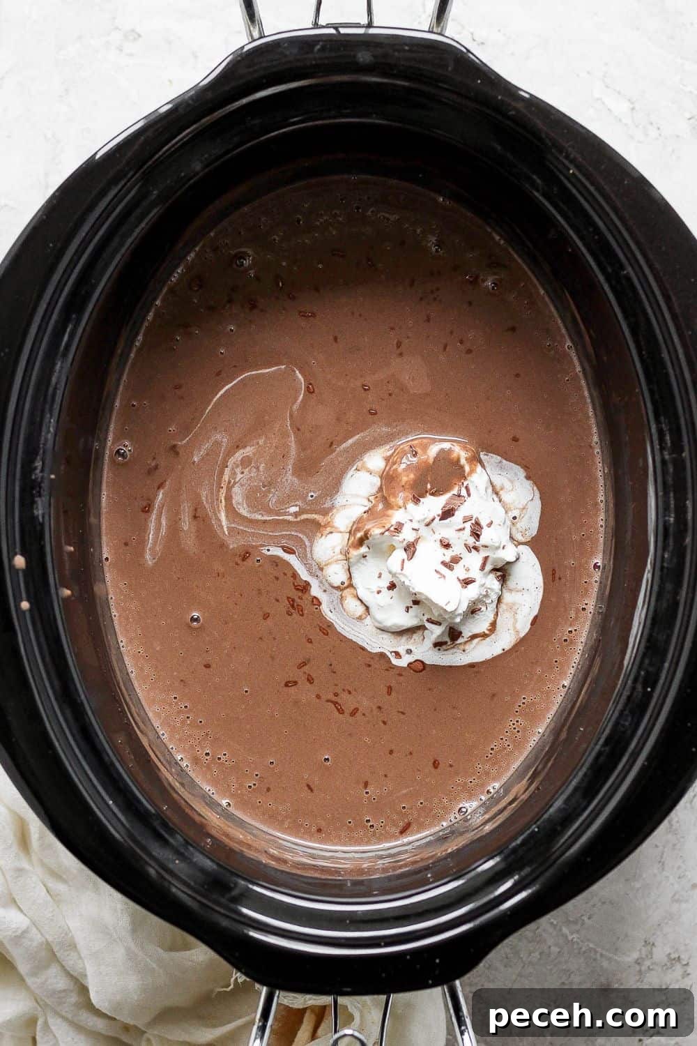 Completely melted and warmed hot chocolate in crock pot with a dollop of whipped cream.