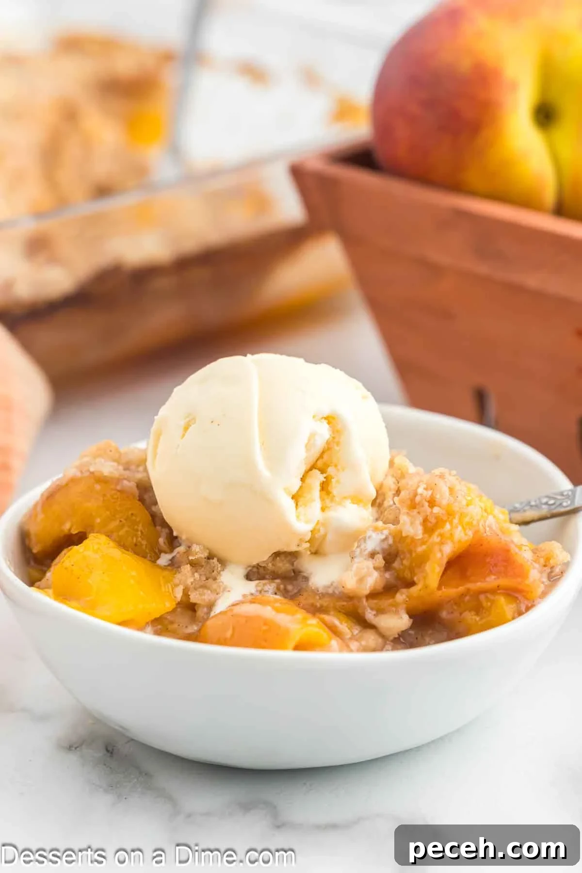 Perfect Peach Crumble Recipe for Summer Desserts 2 Peach crumble is a serving bowl topped with ice cream.