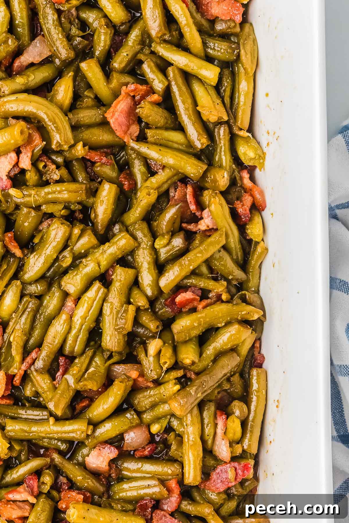 Quick and Flavorful Canned Green Beans Recipe 3 Canned Green Beans Recipe served in a 9x13 dish with glossy sweet and savory coating