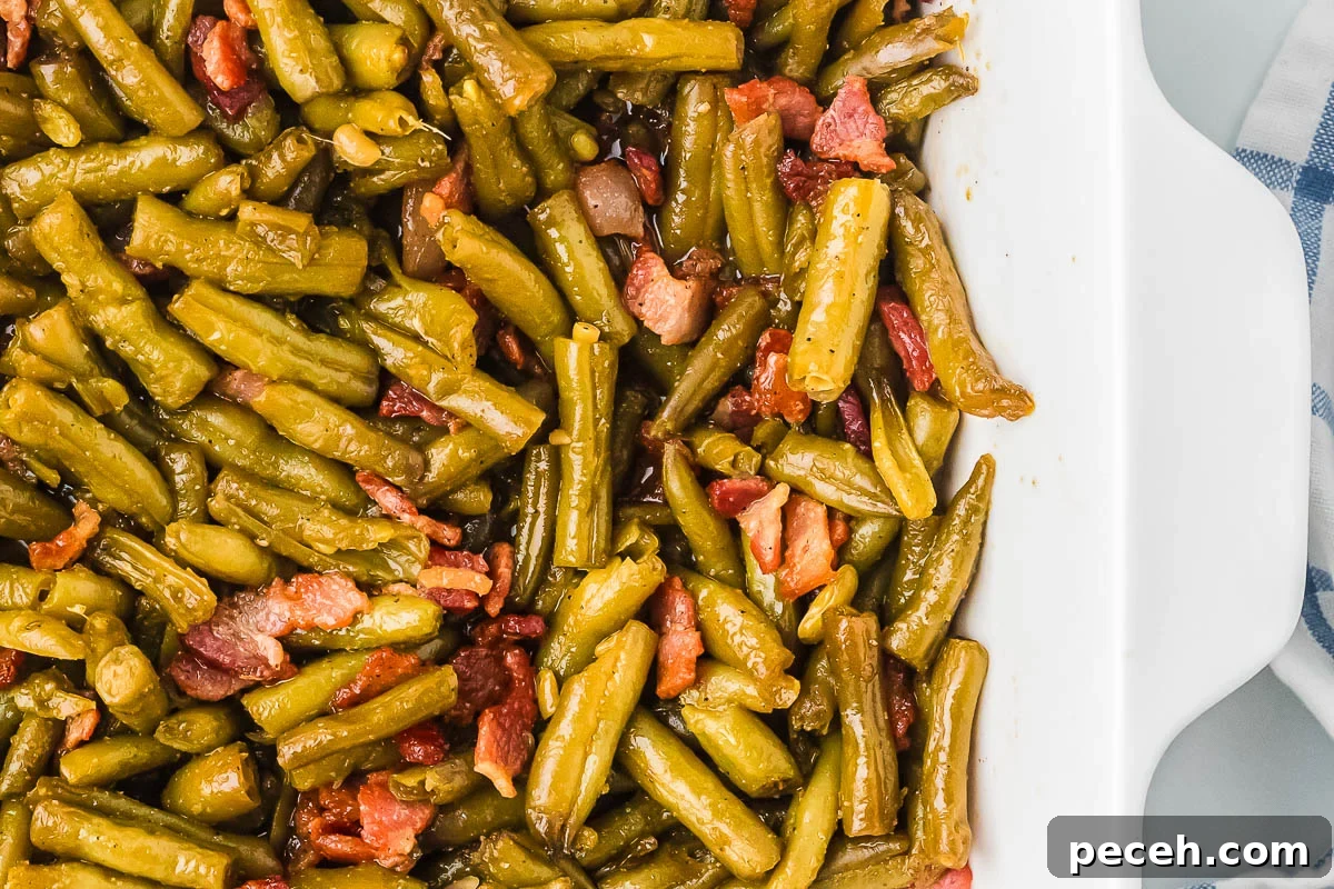 Quick and Flavorful Canned Green Beans Recipe 10 baking dish with glossy vegetable bake and bacon