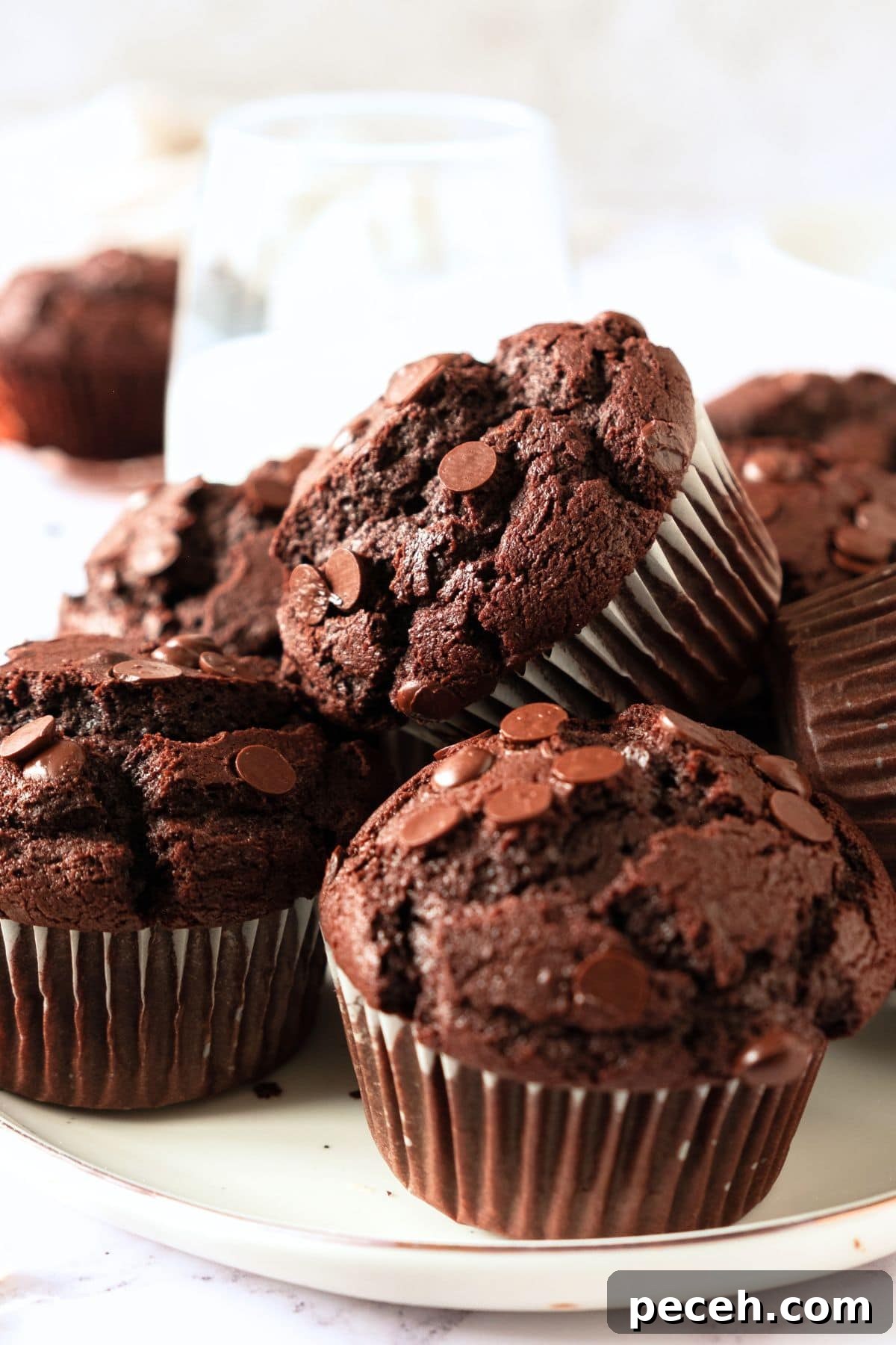 Gluten-Free Double Chocolate Muffins (Dairy-Free Option) Up close view of a plate of gluten-free double chocolate muffins.