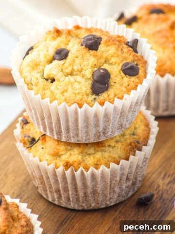 A stack of almond flour chocolate chip muffins on wooden board
