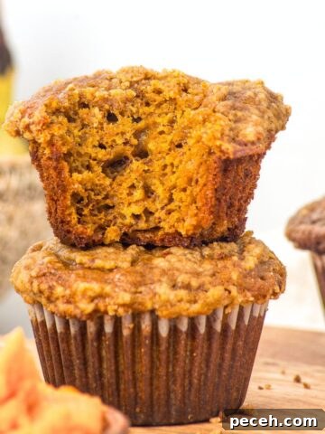 A stack of half-eaten gluten-free pumpkin banana muffins.