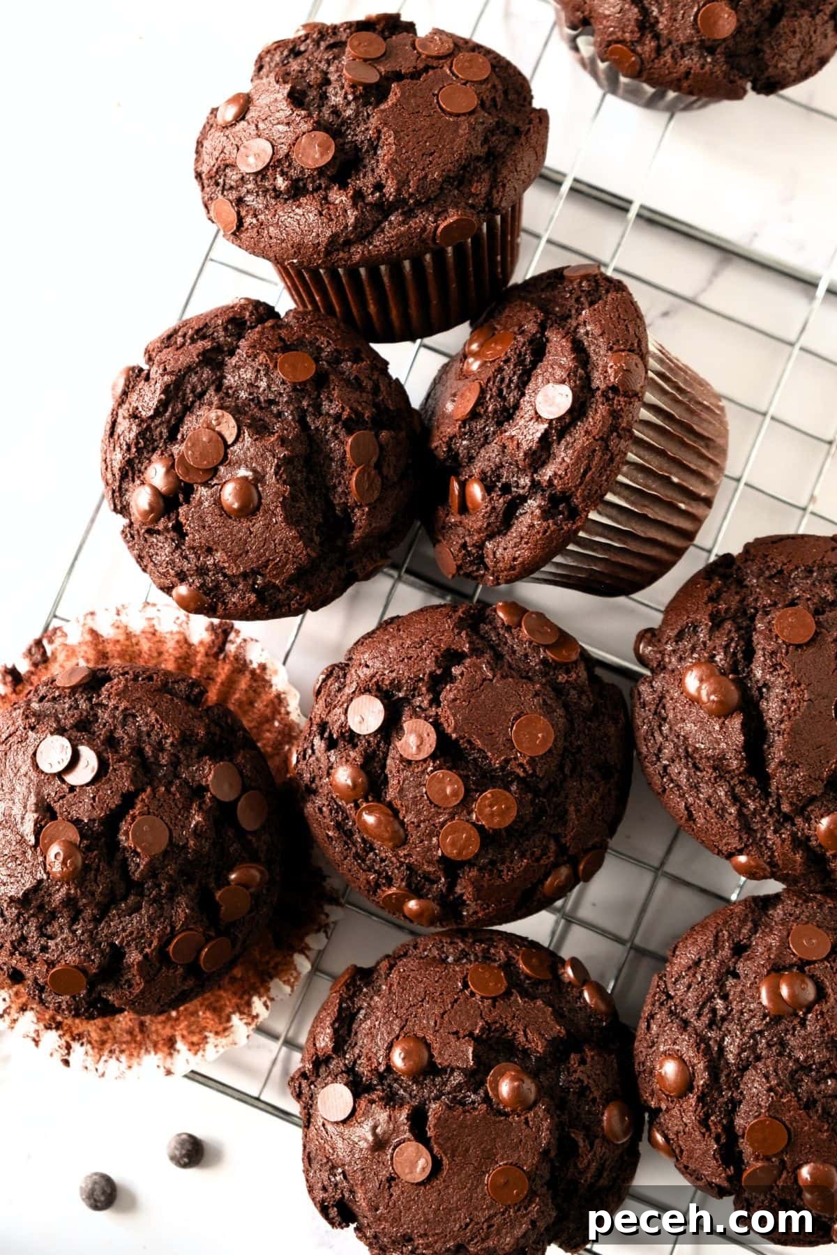 Easy Gluten-Free Chocolate Muffins (Dairy-Free Option) Top down view of gluten-free chocolate muffins on wire rack.