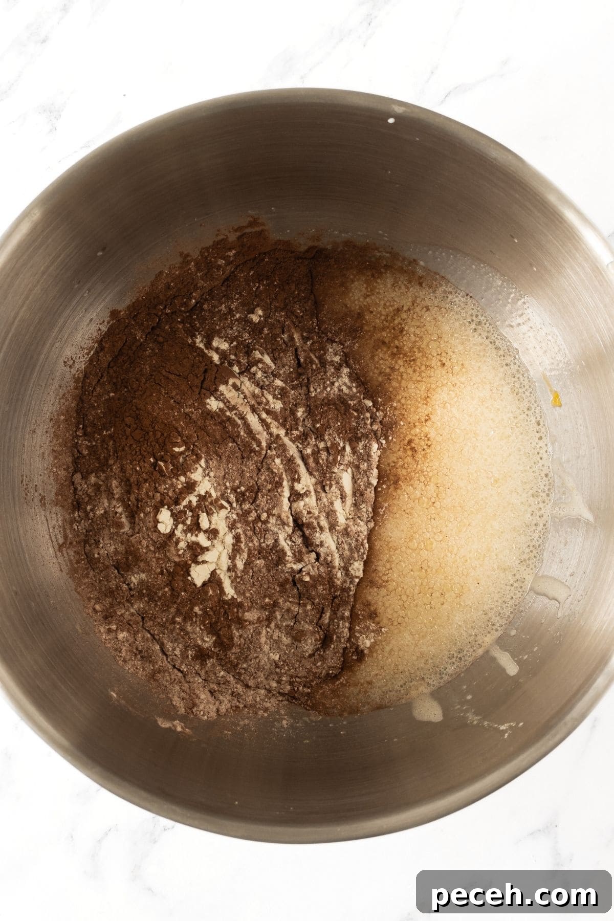 How to Make Gluten-Free Chocolate Muffins Chocolate flour mixture with pale yellow liquid in bowl