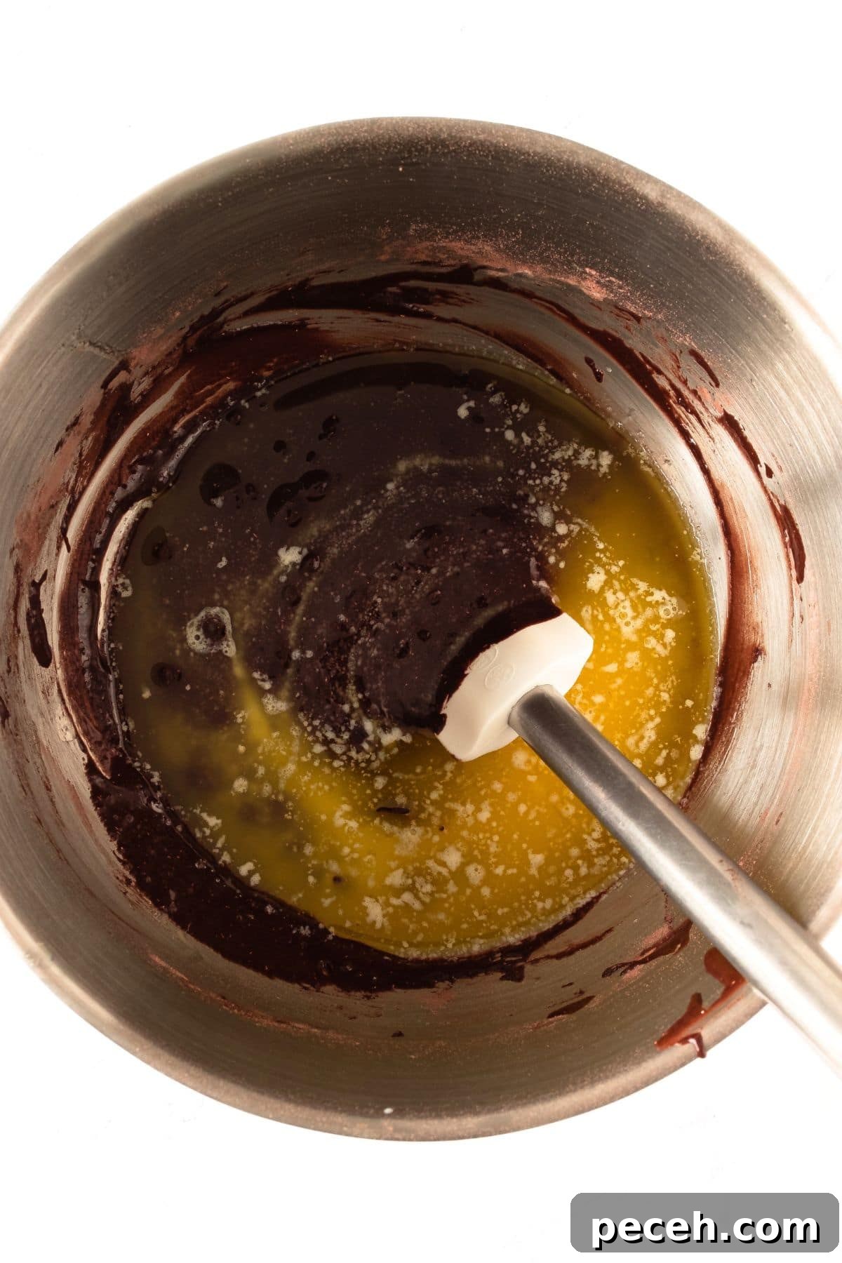 Gluten-Free Double Chocolate Muffins (Dairy-Free Option) Mixing melted chocolate and butter in bowl