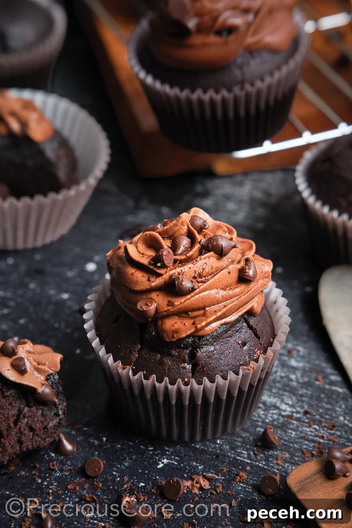 Decadent Chocolate Cupcakes with Silky Chocolate Frosting 17 A frosted chocolate cupcake topped with chocolate chips.