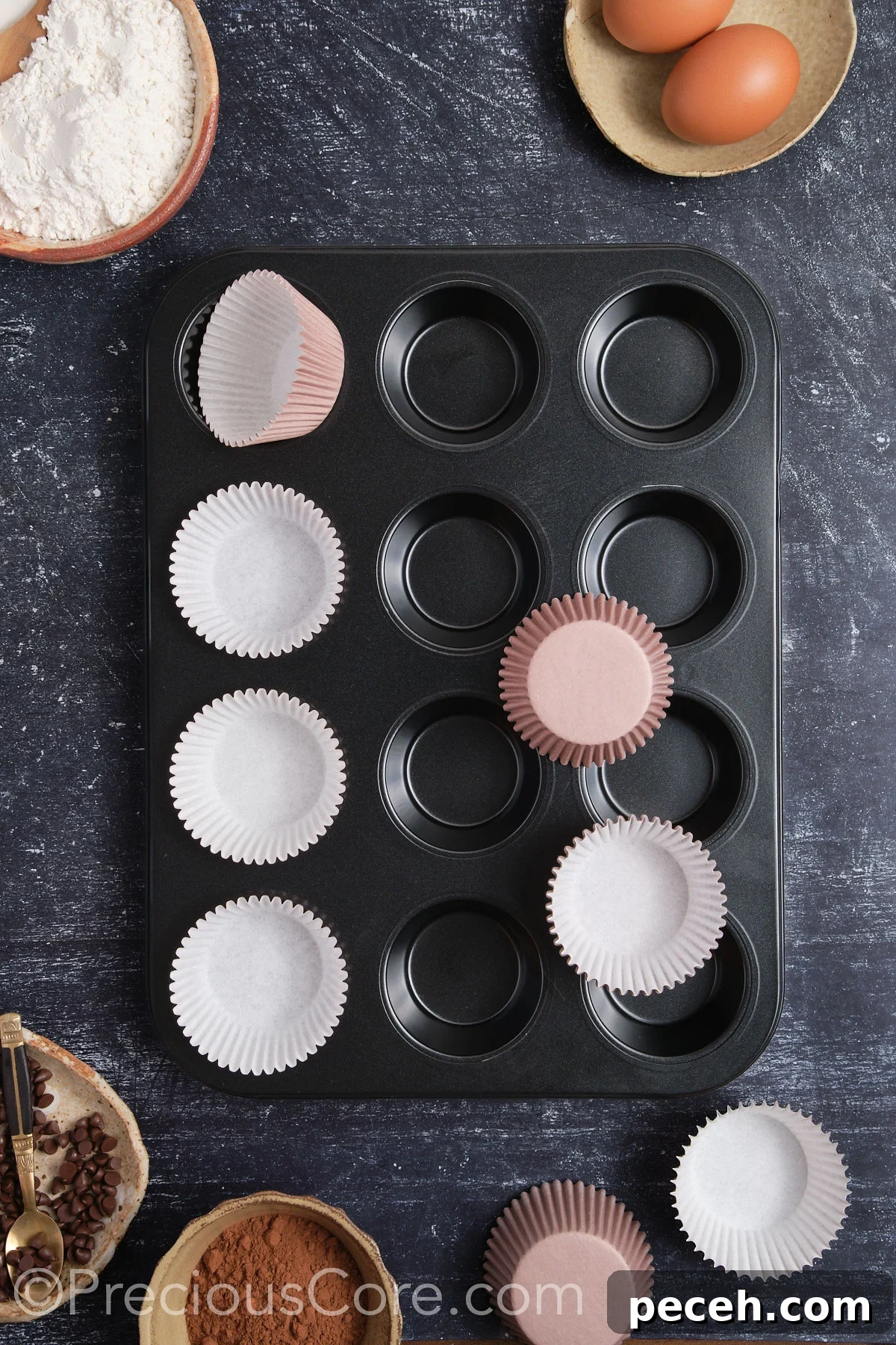 Decadent Chocolate Cupcakes with Silky Chocolate Frosting 6 Lining a muffin pan with cupcake liners.
