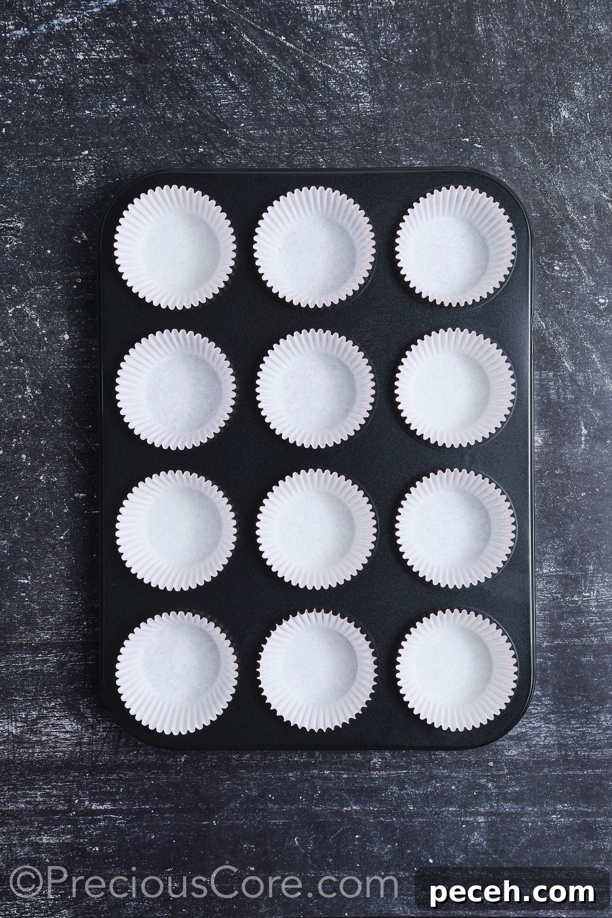 Decadent Chocolate Cupcakes with Silky Chocolate Frosting 7 A muffin pan fully lined with cupcake liners.