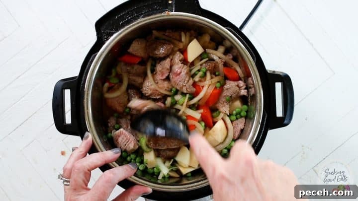 Instant Pot Lamb Stew Recipe: Tender, Flavorful One-Pot Meal 6 Adding the lamb, potatoes, peas, and herbs to the Instant Pot.