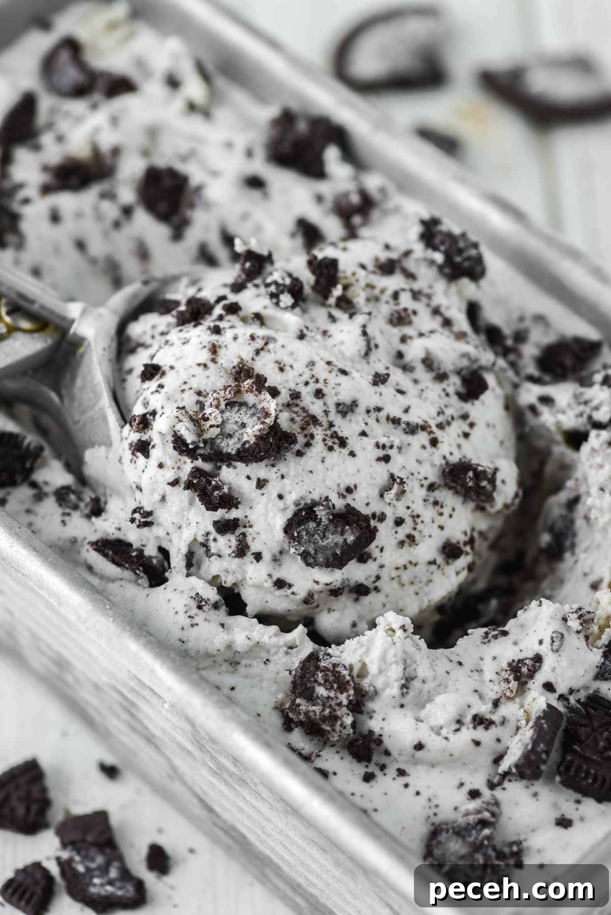 close-up of ice cream scoop scooping out ice cream from metal tin