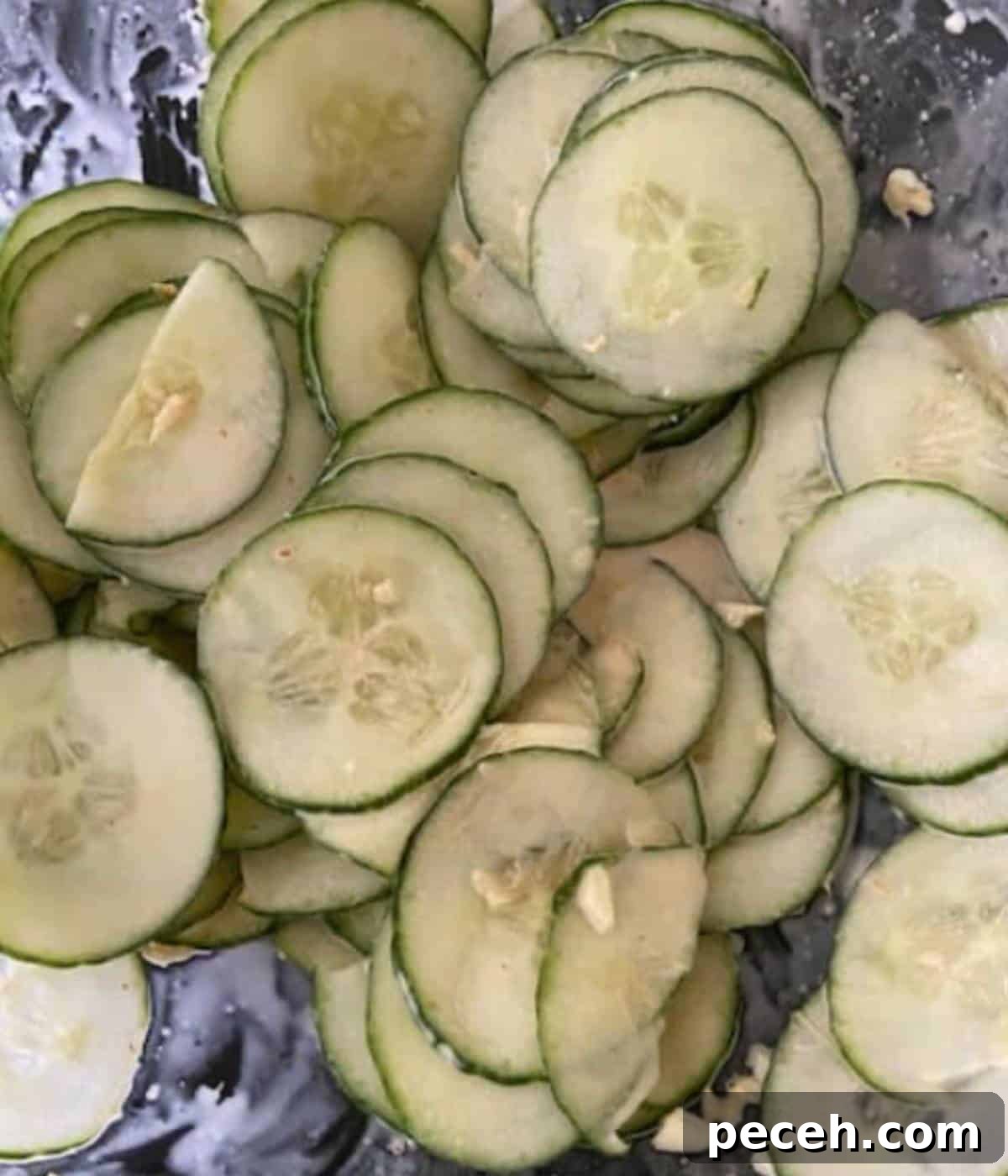 Spicy Asian Cucumber Salad Recipe with Chili and Sesame 6 Cucumbers in sauce in bowl.
