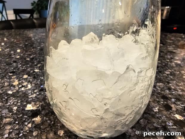 Honey Almond Iced Latte - The Grateful Girl Cooks! A glass cup is filled with crushed ice before adding the latte mix.