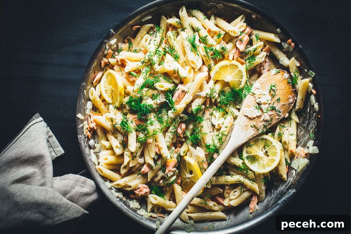 creamy lemon vodka salmon pasta in skillet overhead