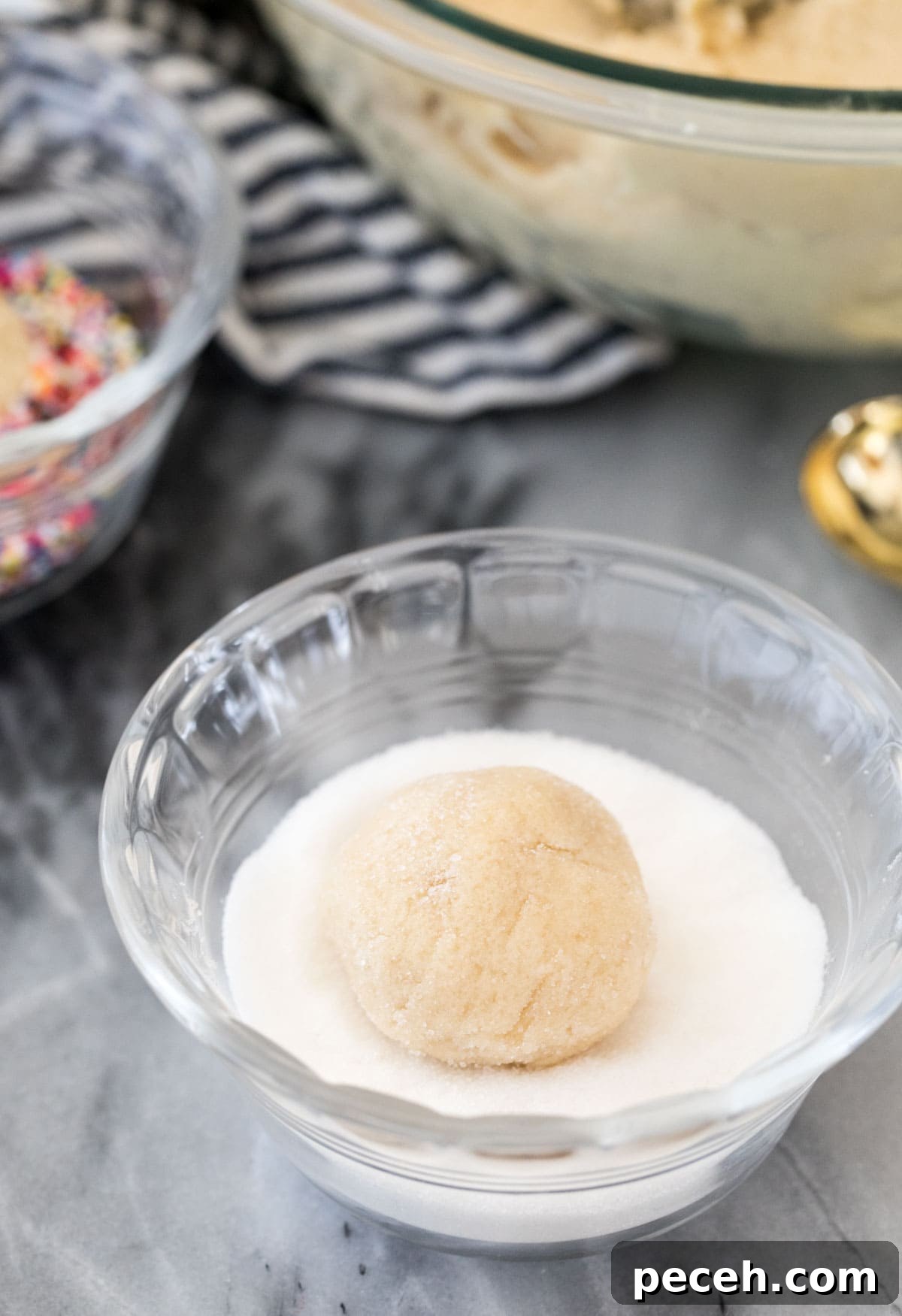 Soft and Chewy Cream Cheese Cookie Recipe for Perfect Bakes 5 rolling cookie dough ball through granulated sugar