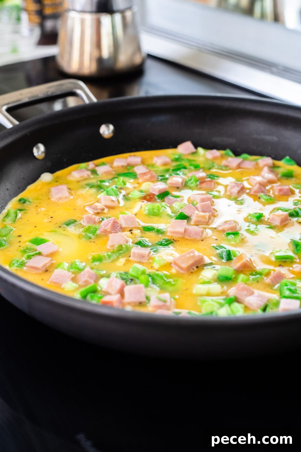 Classic Western Omelette Sandwich Recipe: How to Make It at Home 6 A Western omelette cooking in a skillet.