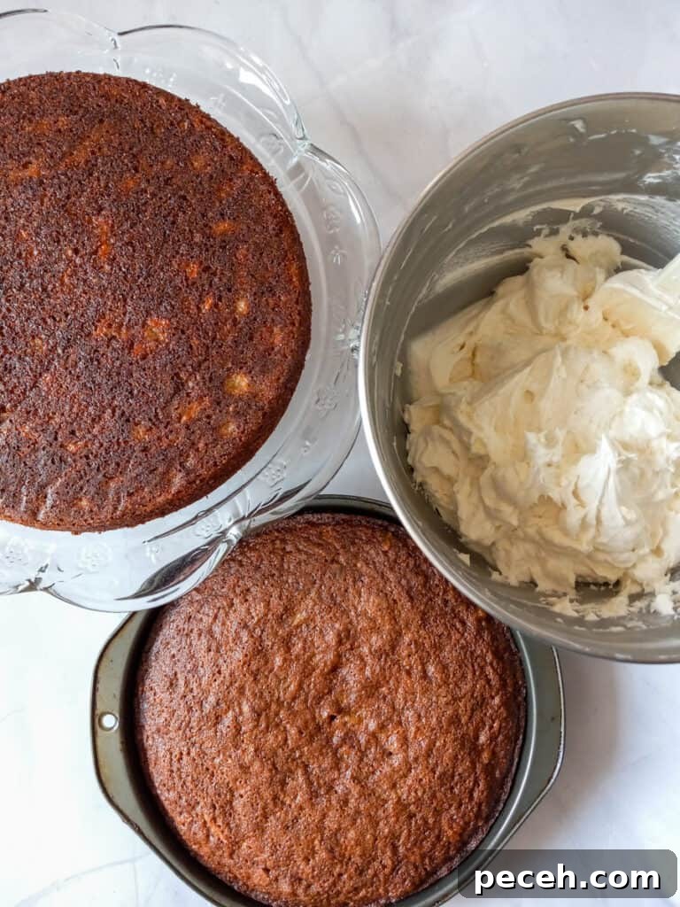 Amish Pineapple Carrot Cake with Pecans – Traditional Recipe 6 one 9" cake on a cake stand, another one in a pan, and frosting in a bowl.