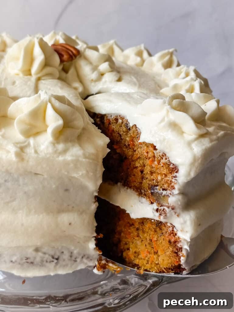 Amish Pineapple Carrot Cake with Pecans – Traditional Recipe 8 a slice of carrot cake cut out of the whole cake to show the inside.