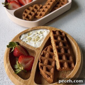 Banana oat waffles served with berries and yogurt.