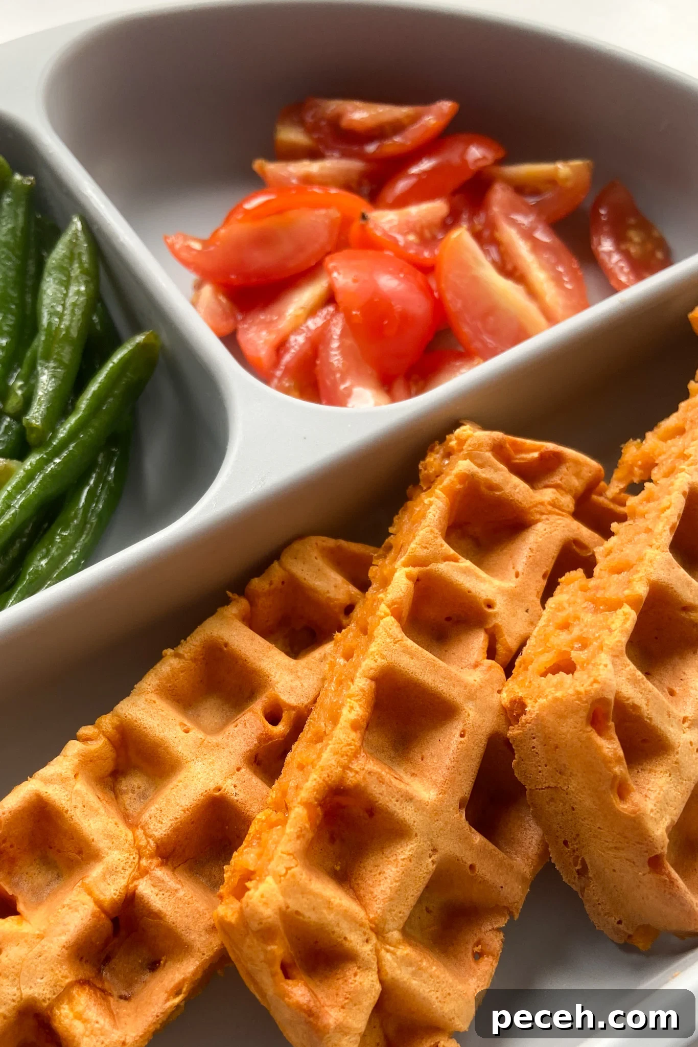 Waffle Recipes for Babies and Toddlers: 10+ Nutritious Ideas 7 Pizza waffles served with green beans and quartered tomatoes