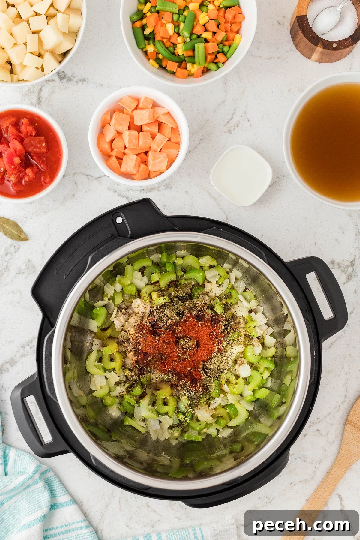Top view of an Instant Pot with chopped celery, onion, and spices, surrounded by bowls of diced veggies—perfect for making soup in an Instant Pot or pressure cooker as a quick 30 Minute Meal.