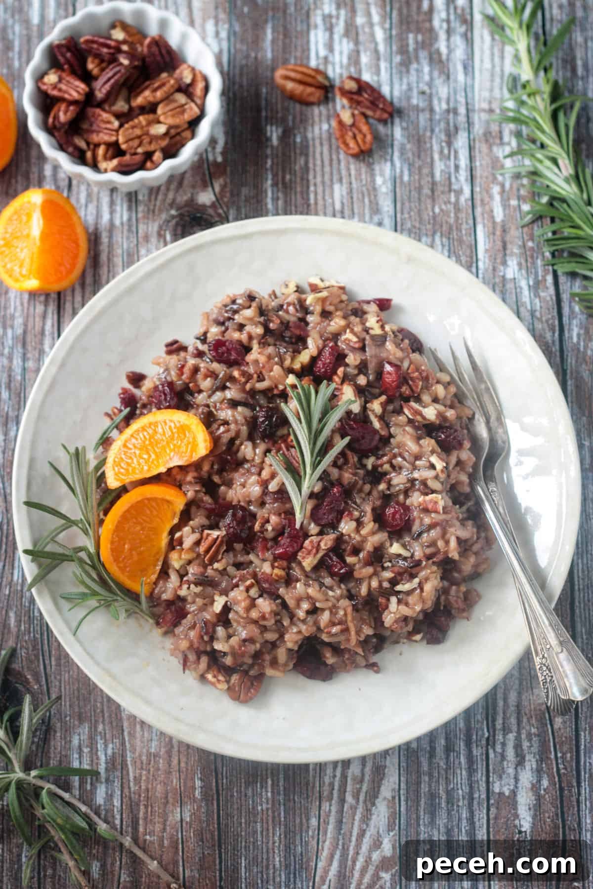 Thanksgiving Wild Rice Pilaf with Cranberries and Toasted Pecans 3 A fork on a plate next to the finished dish.