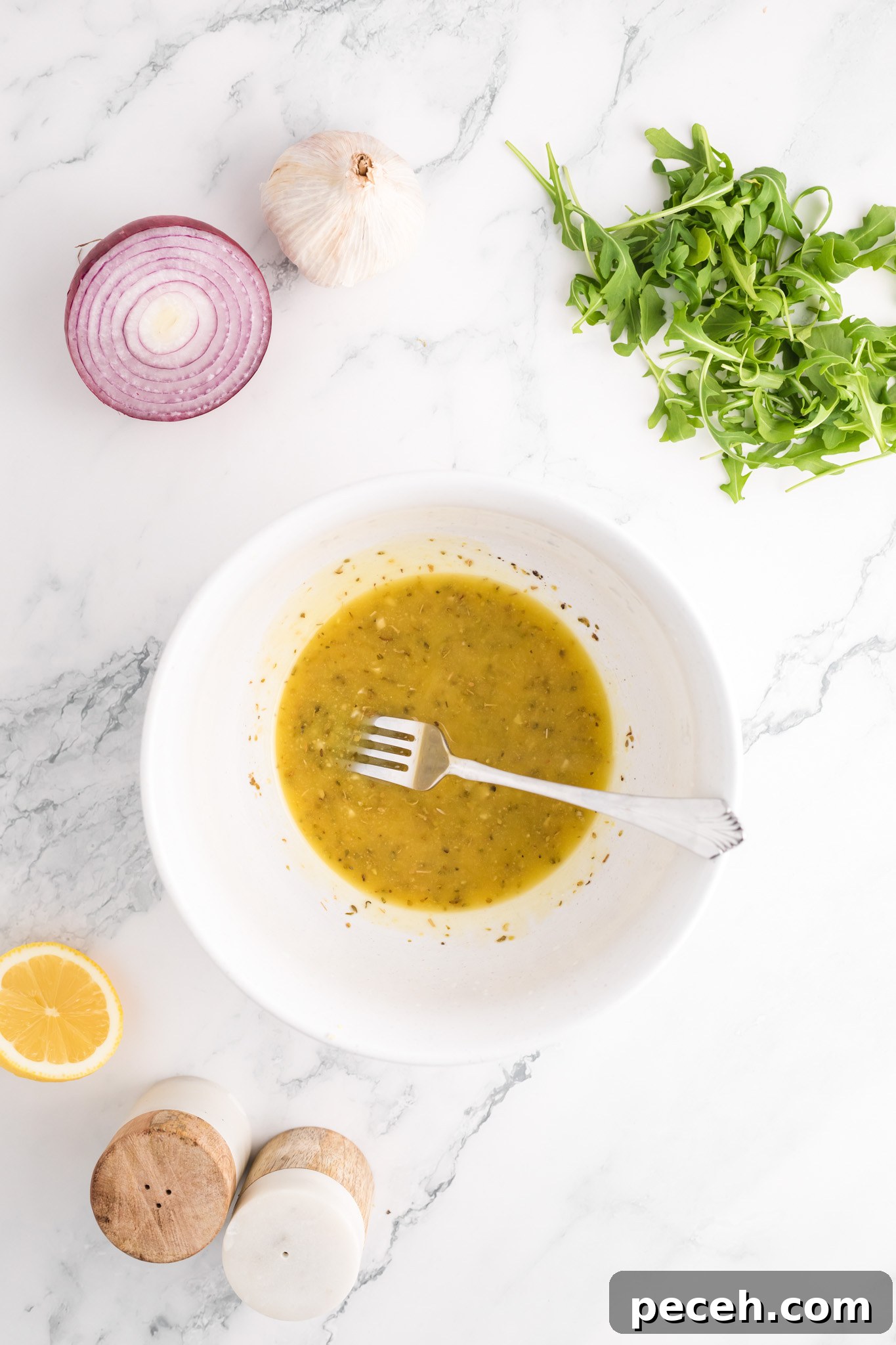 Zesty Arugula and Lemon Orzo Salad with Parmesan 8 Arugula Orzo Salad salad dressing in a bowl.