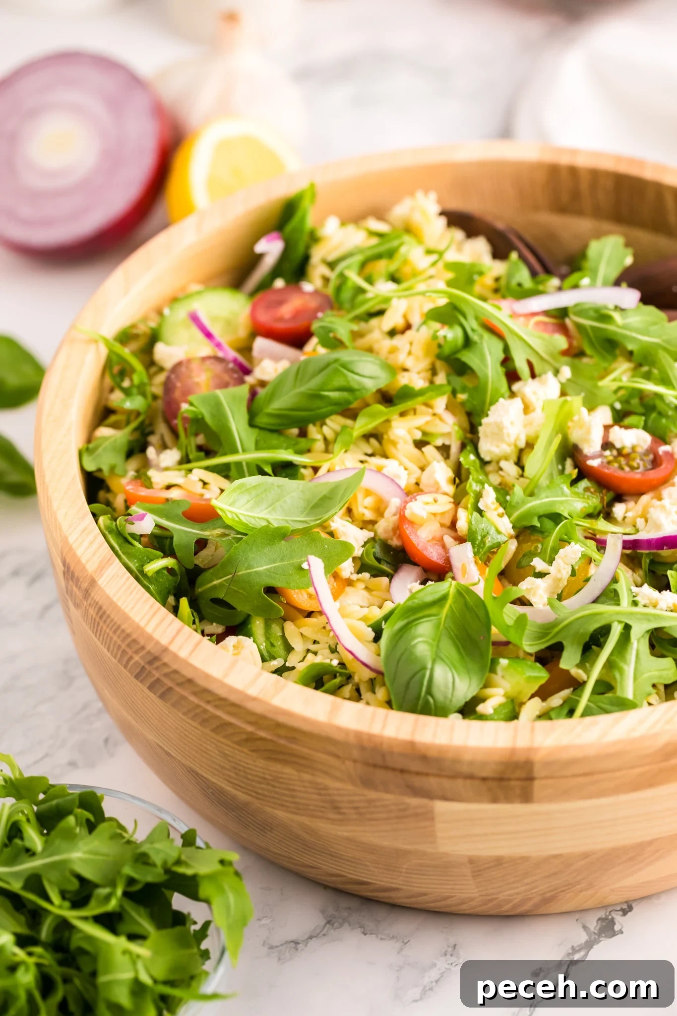 Zesty Arugula and Lemon Orzo Salad with Parmesan 10 Arugula Orzo Salad in a wooden bowl.
