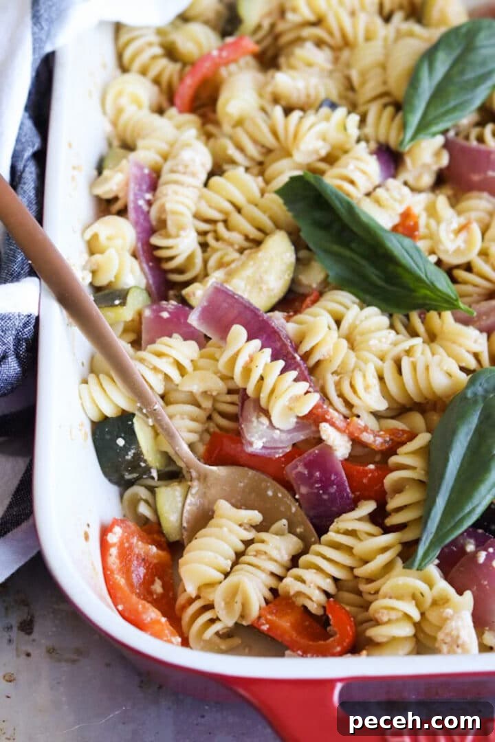 Roasted Feta Pasta with Extra Vegetables 2 Baking pan with baked feta pasta with more vegetables prepared, topped with fresh basil