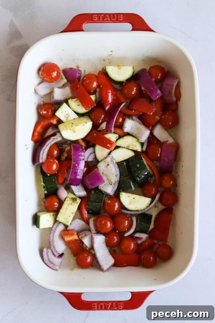 Roasted Feta Pasta with Extra Vegetables 5 Raw vegetables and a block of feta in a baking dish