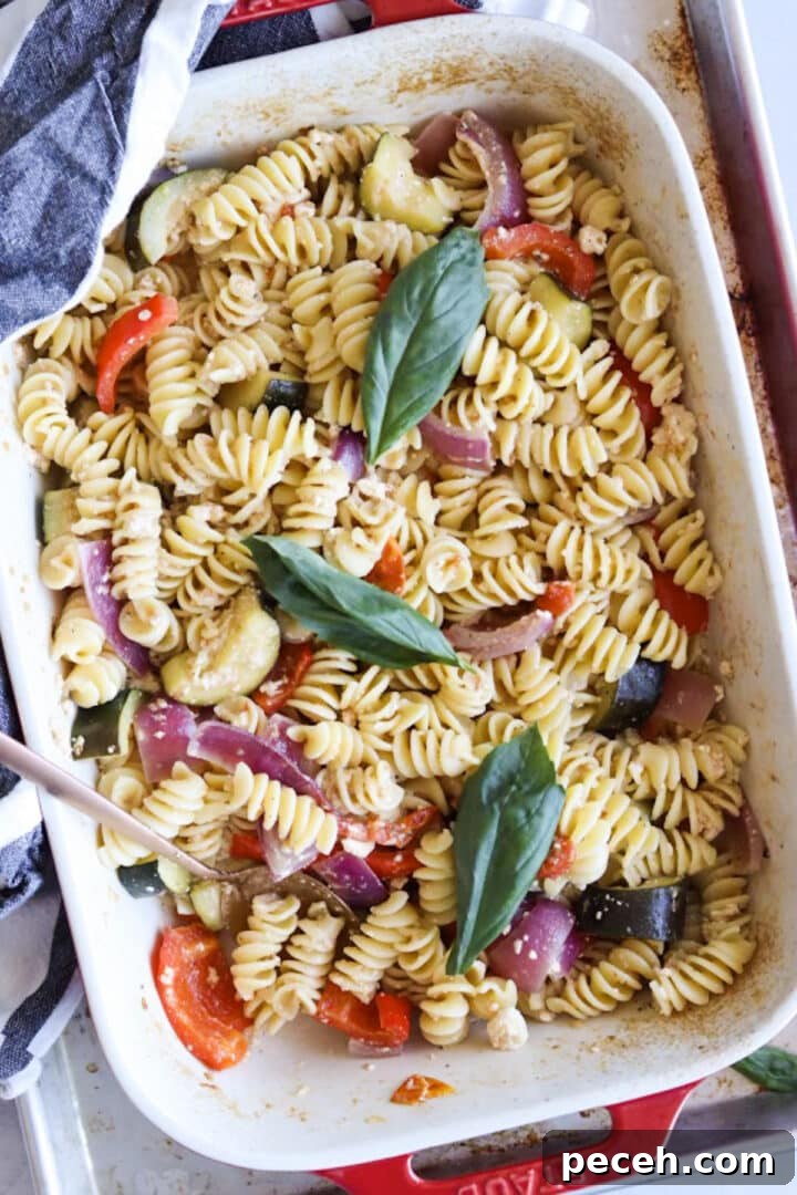 Roasted Feta Pasta with Extra Vegetables 9 Baking dish with finished baked feta pasta and a gold spoon