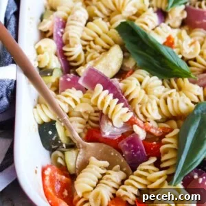Roasted Feta Pasta with Extra Vegetables 10 Baking pan with baked feta pasta with more vegetables prepared, topped with fresh basil