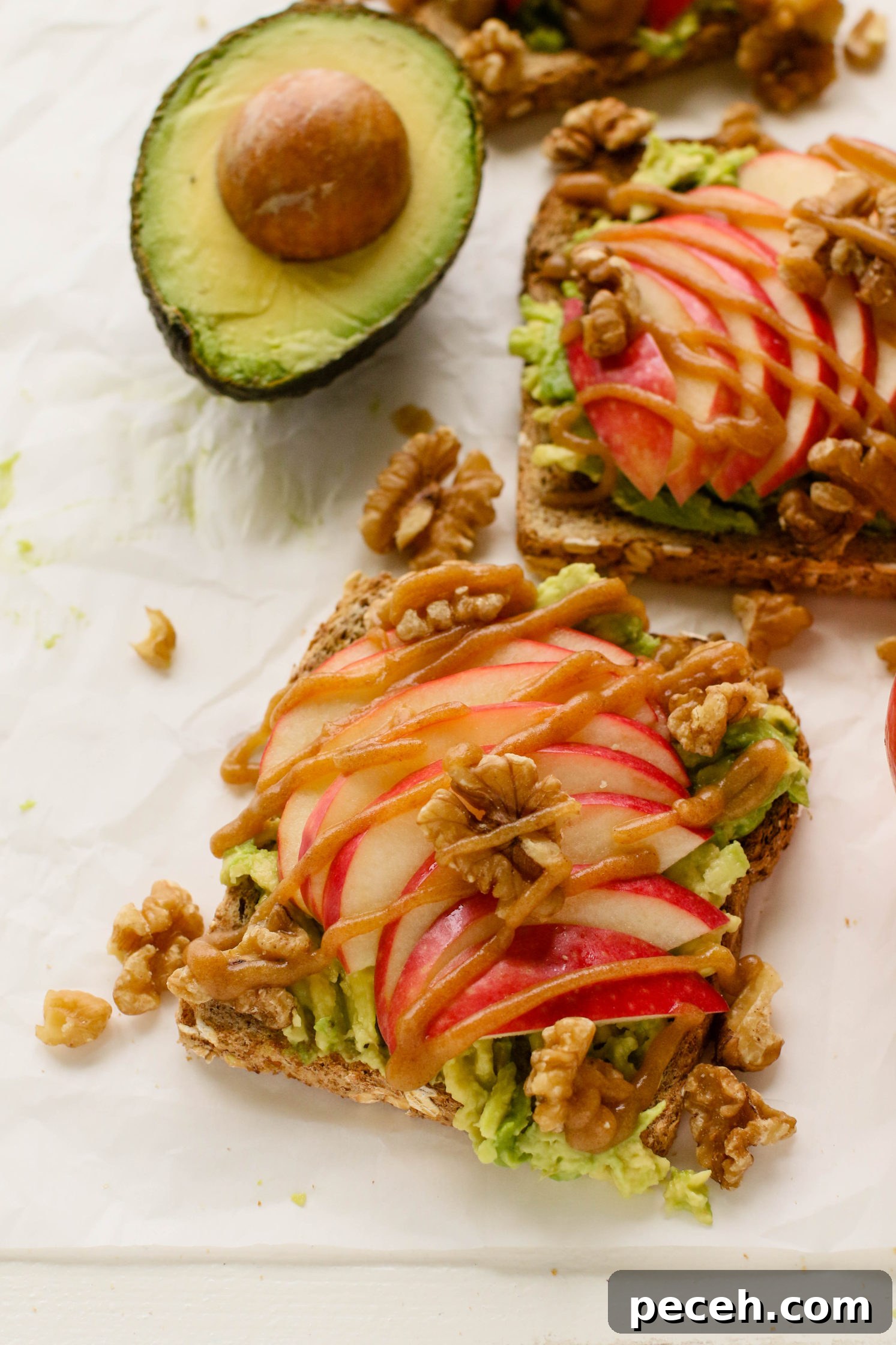 Apple Pie Avocado Toast Recipe: Cinnamon Maple Fall Breakfast 7 apple pie avocado toast served on plates with date caramel drizzled on top with crushed walnuts