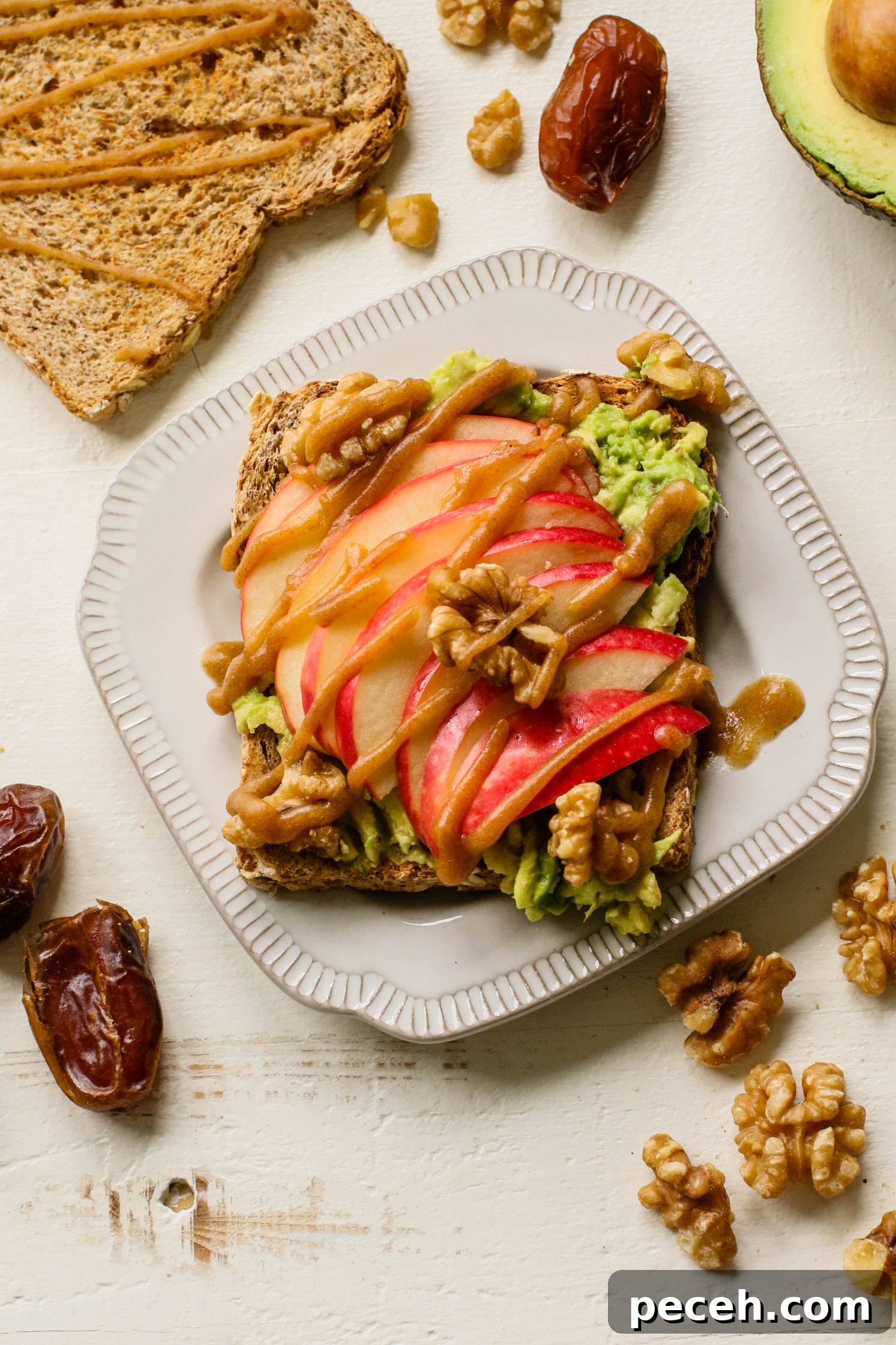 Apple Pie Avocado Toast Recipe: Cinnamon Maple Fall Breakfast 8 apple pie avocado toast served on plates with date caramel drizzled on top with crushed walnuts