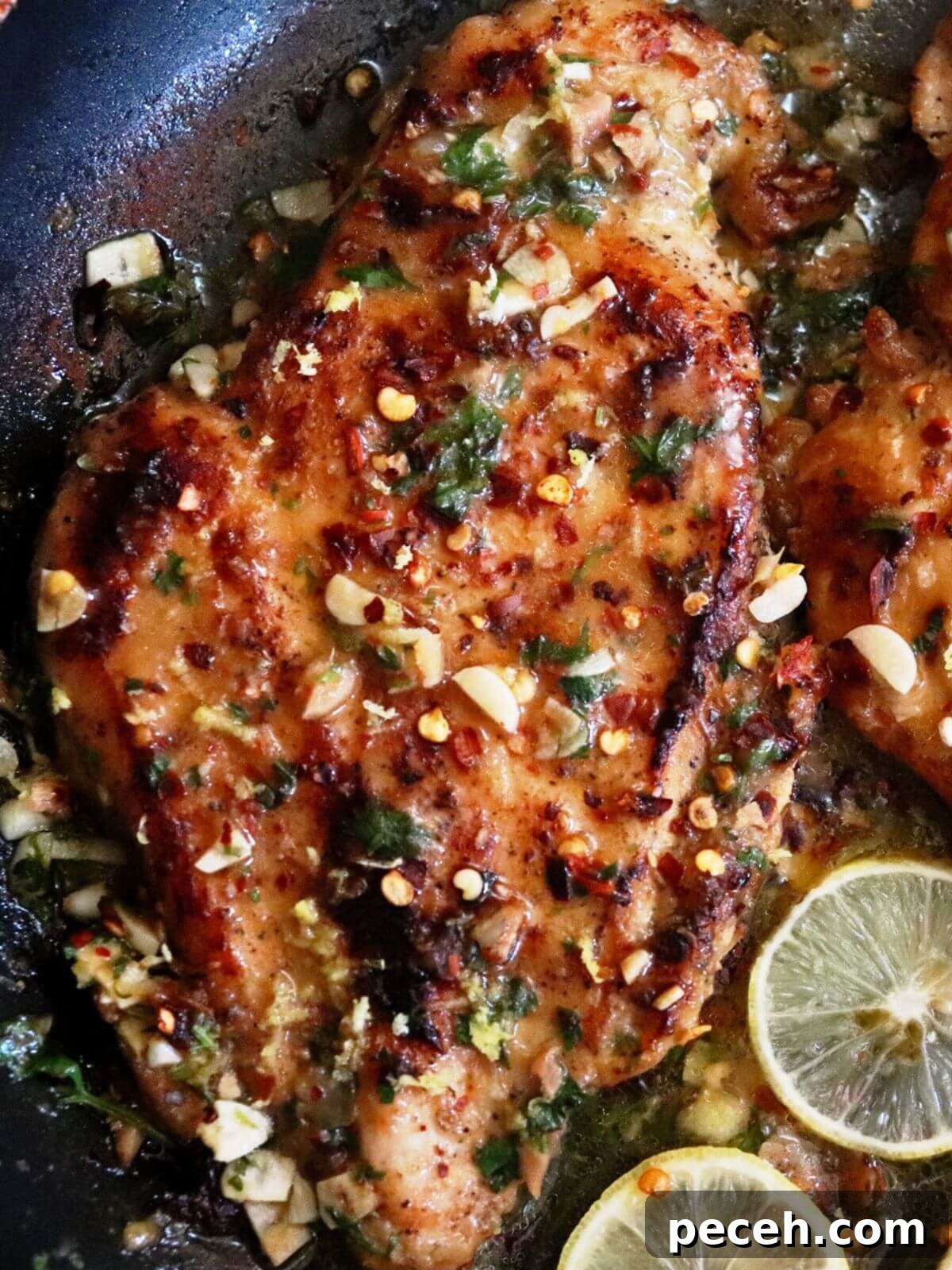 Pan-Seared Lemon Garlic Chicken Breast Recipe 2 close-up of lemon garlic chicken in a pan.