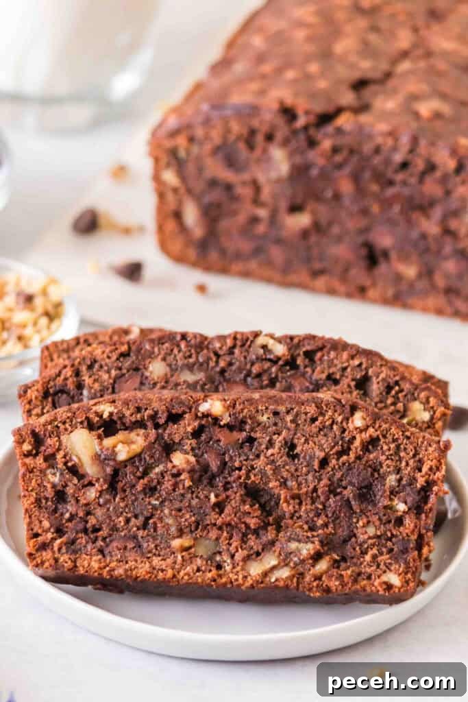 Close up of sliced brownie banana bread showing chocolate chips and walnuts inside.