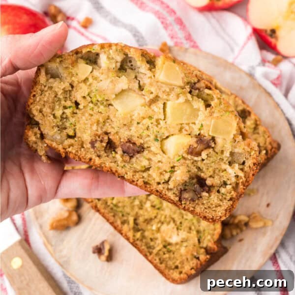 hand holding a slice of apple zucchini bread