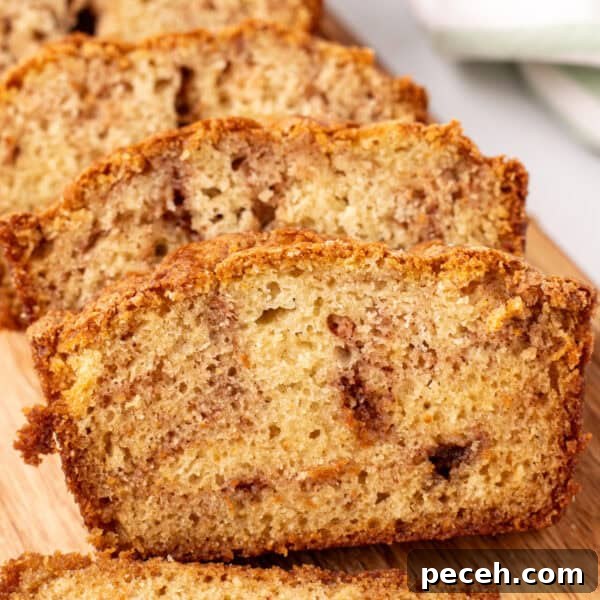 close-up square image of sliced Amish Cinnamon Bread stacked on a cutting board showing the golden crust and soft cinnamon-swirled crumb