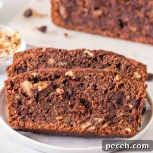 Square image of sliced brownie banana bread showing chocolate chips and walnuts in the crumb.
