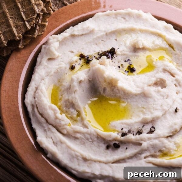 Homemade Hummus: Classic Chickpea or Creamy White Bean Recipe 3 white bean hummus with drizzle of oil and fresh cracked pepper