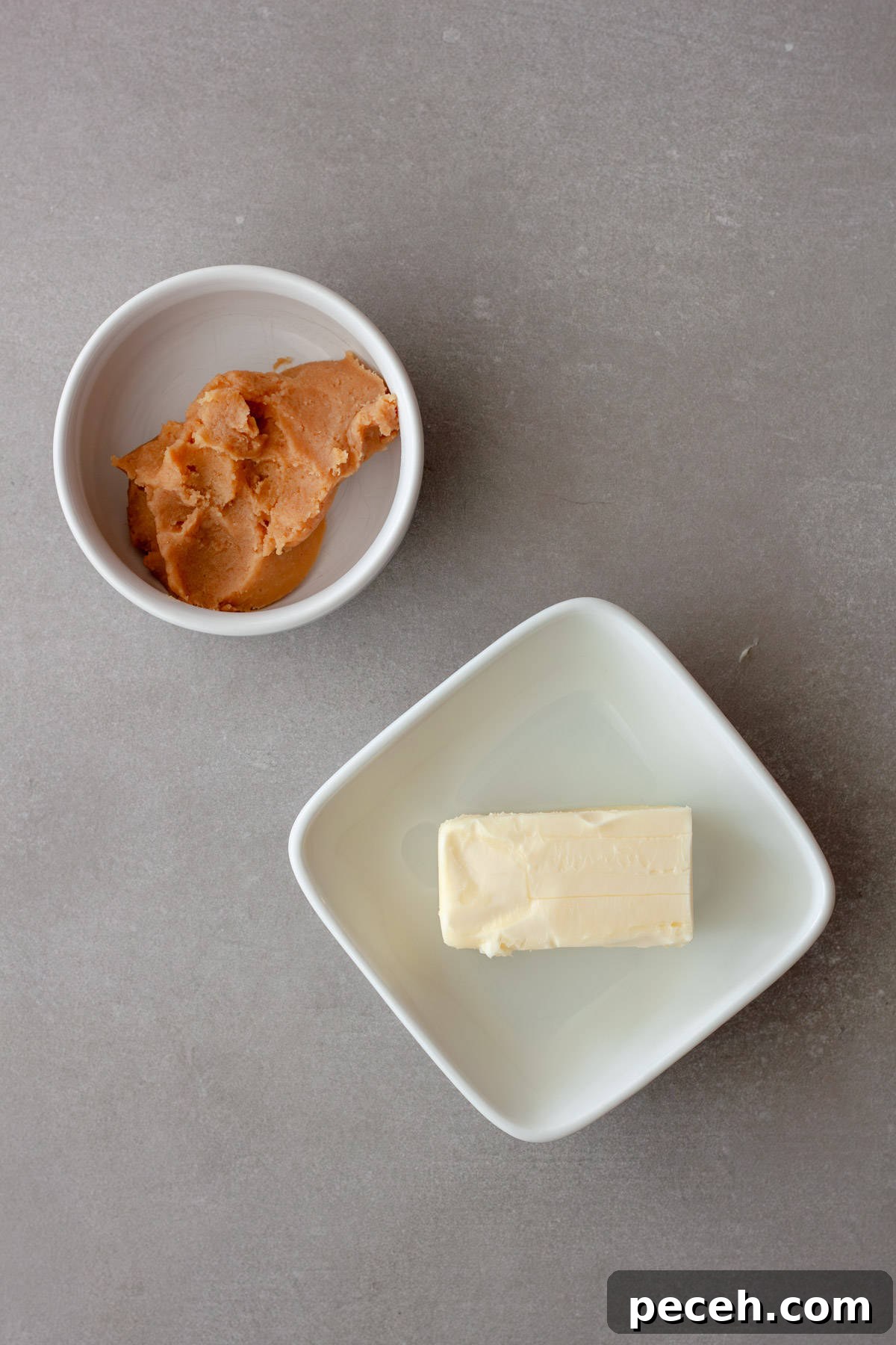Savory Miso Butter Recipe for Bread, Veggies, and Steak 3 Miso and butter in small dishes on a gray table.