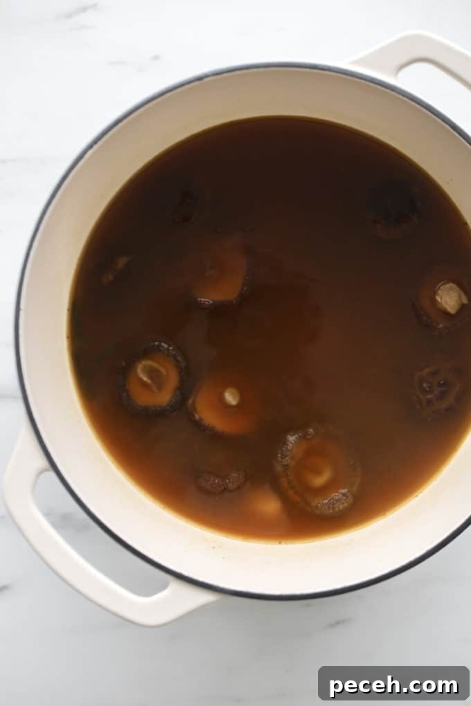 Vegan Ramen Recipe: Fast Homemade Broth and Noodles 9 A white pot with vegan ramen broth in it