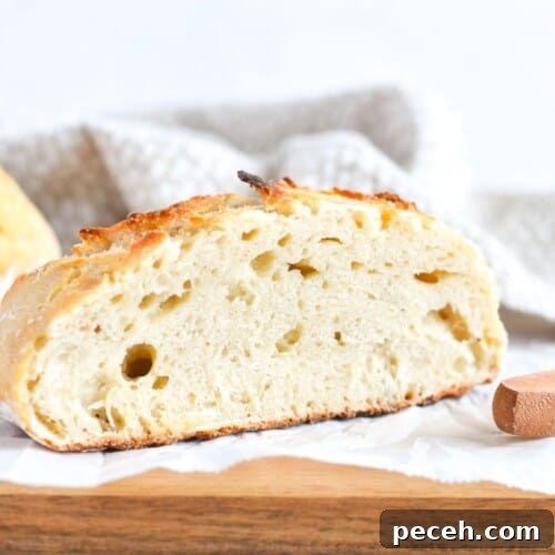 bread sliced in half on wooden cutting board.